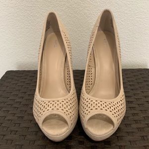 Tan suede peep toe pumps.